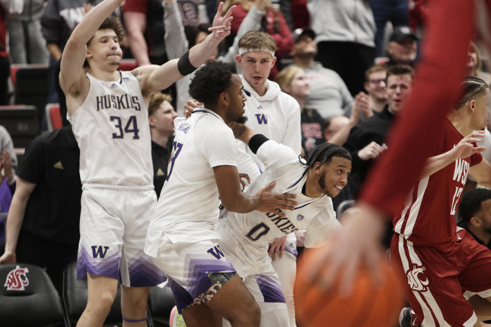 Washington guard Koren Johnson (0) celebrates with teammates after his basket during the second half of an NCAA college basketball game against Washington State, Thursday, March 7, 2024, in Pullman, Wash. (AP Photo/Young Kwak)