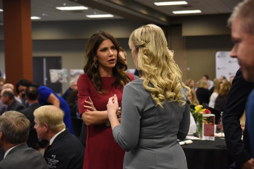 Gov. Kristi Noem speaks to Sen. Jessica Castleberry at the Governor's Annual Luncheon at Lake Area Technical College in Watertown on May 6, 2022.