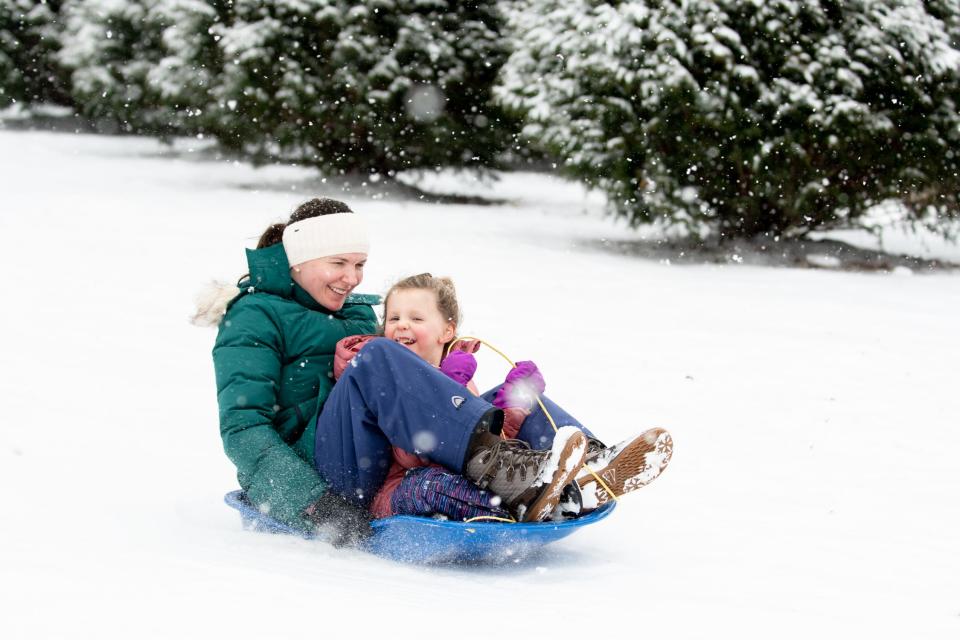 Rochelle Turchen, of Doylestown Borough, sleds down a hill with her daughter, Lorelei, 5, outside Mercer Museum in Doylestown Borough, during a winter storm that impacted the region on Friday, January 19, 2024.