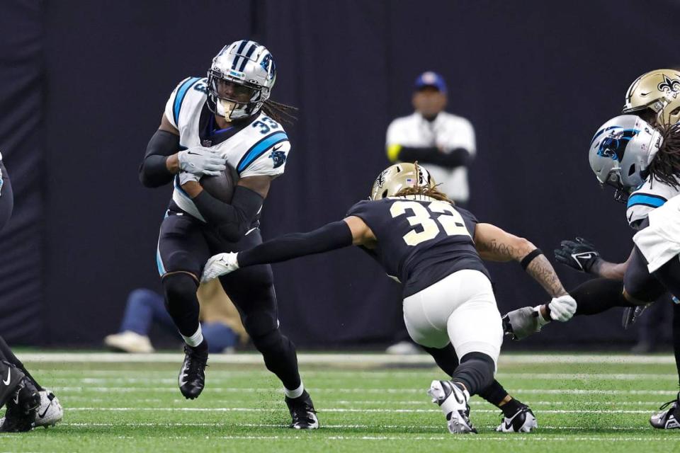 Carolina Panthers running back D’Onta Foreman (33) runs the ball past New Orleans Saints safety Tyrann Mathieu (32) during an NFL football game, Sunday, Jan. 8, 2023, in New Orleans. (AP Photo/Tyler Kaufman) Tyler Kaufman/AP