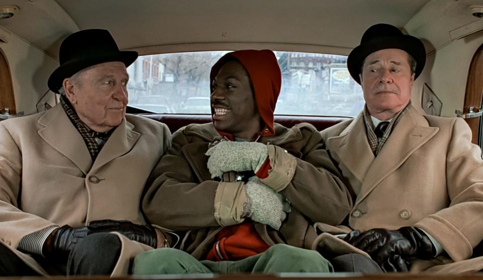 Ralph Bellamy, Eddie Murphy, and Don Ameche in the back of a Rolls Royce. (Alamy)