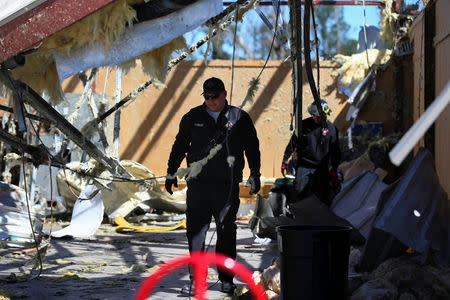 A lieutenant from the Eufaula Fire Department surveys damage to a Fire Department building at the Eufaula Municipal Airport, after a string of tornadoes, in Eufaula, Alabama, U.S., March 5, 2019. REUTERS/Elijah Nouvelage