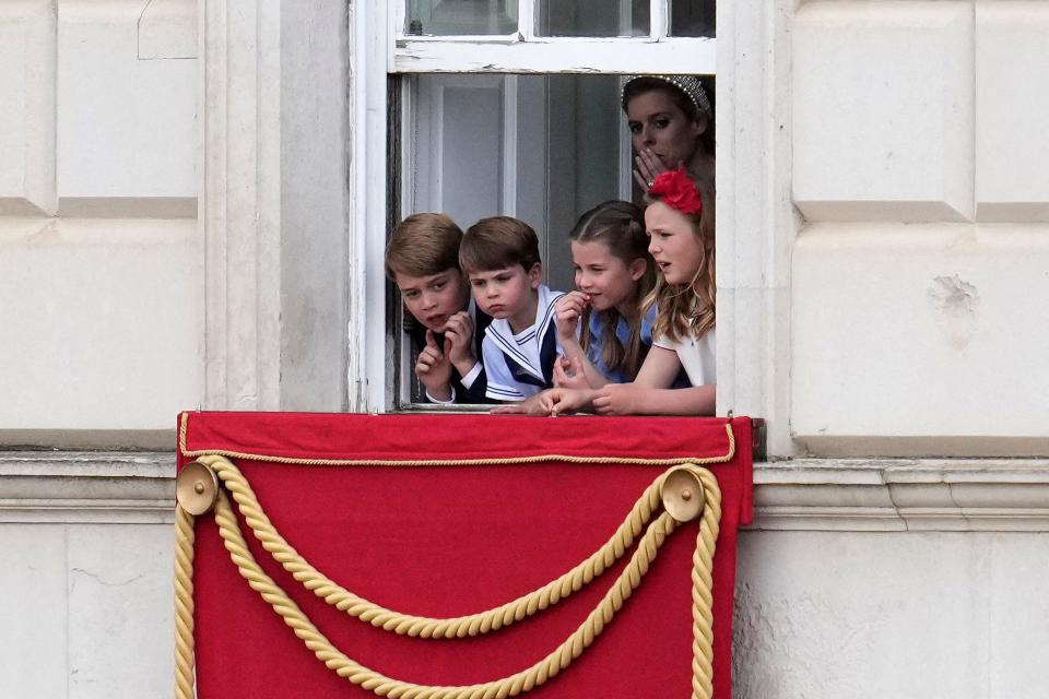 Princess Beatrice with Prince George, Princess Charlotte, Mia Tindall, and Prince Louis in a window at Buckingham Palace.