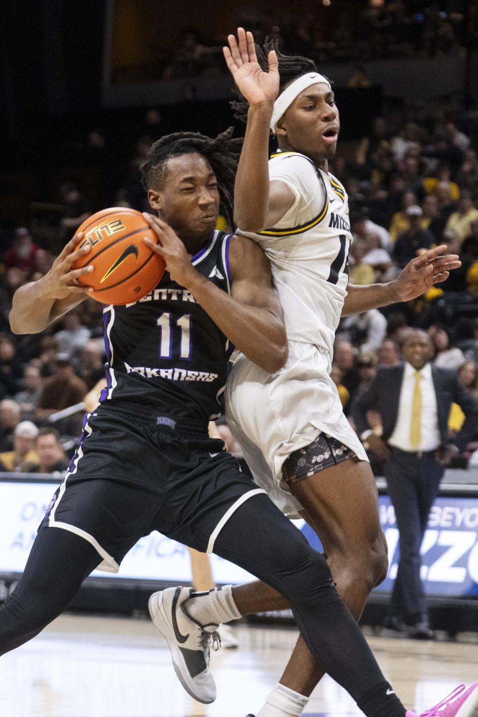 Central Arkansas' Carl Daughtery Jr., left is fouled by Missouri's Anthony Robinson II, right, during the first half of an NCAA college basketball game Saturday, Dec. 30, 2023, in Columbia, Mo. (AP Photo/L.G. Patterson)