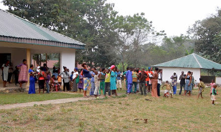 A still image taken from a video shot on December 9, 2017 shows Cameroonian refugees standing outside a center in Agbokim Waterfalls village, which borders on Cameroon, Nigeria. REUTERS/via Reuters TV