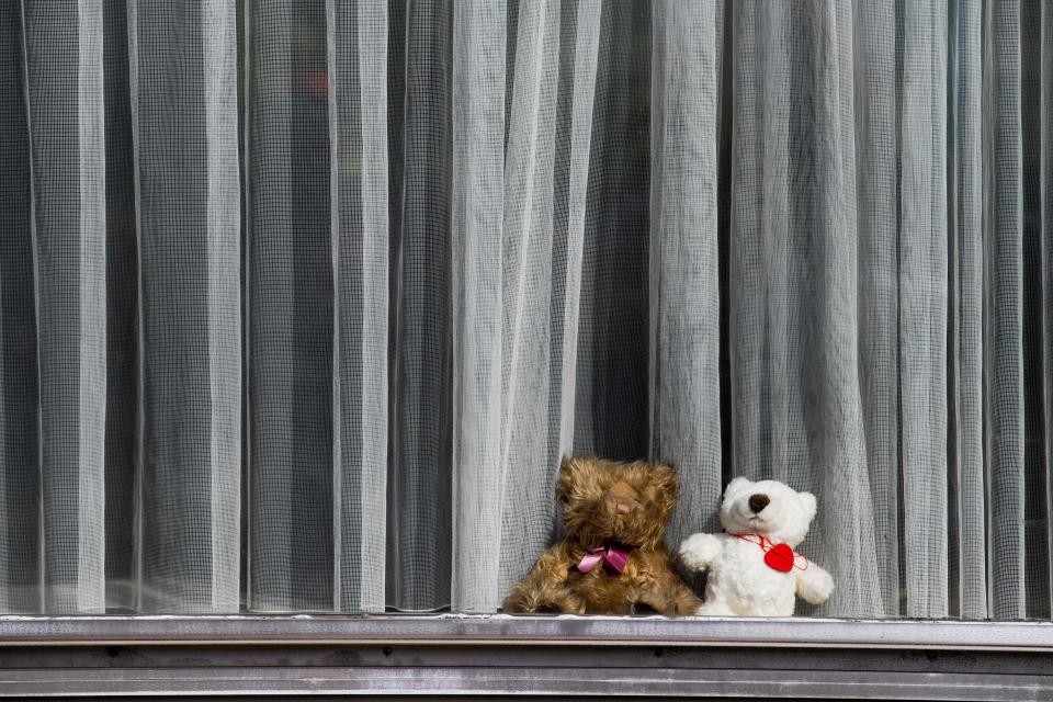 Teddy bears are placed on a windowsill of a home in Mechelen, Belgium, on March 29, 2020, as a new game for children who are passing by during outside walks, can look for teddy bears and count them.