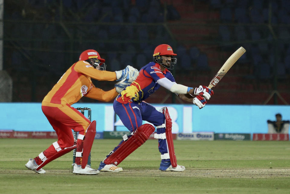 Karachi Kings batsman Umaid Asif, right, plays a shot during a Pakistan Super League T20 cricket match against Islamabad United at the National Stadium in Karachi, Pakistan, Saturday, March 14, 2020. (AP Photo/Fareed Khan)