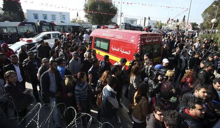 People surround an ambulance carrying the bodies of the victims of an attack by gunmen on Tunisia's national museum in Tunis March 18, 2015. REUTERS/Zoubeir Souissi