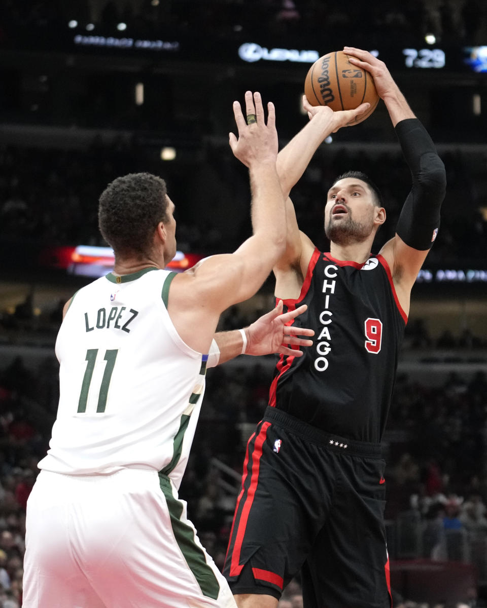 Chicago Bulls' Nikola Vucevic shoots over Milwaukee Bucks' Brook Lopez during the first half of an NBA basketball game, Thursday, Nov. 30, 2023, in Chicago. (AP Photo/Charles Rex Arbogast)