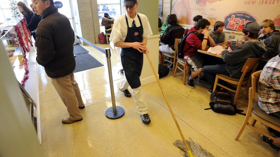 robert price, manager for jersey mike's sub shop across from east high school at the intersection of colfax ave at columbine st, mops the floor during the lunch rushthursday afternoon andy cross, the denver post