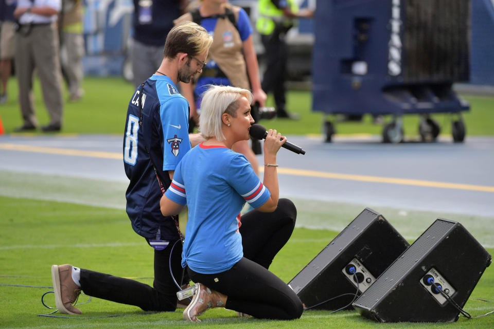 <p>Recording artist Meghan Linsey kneels after singing the national anthem before the game between the Tennessee Titans and the Seattle Seahawks at Nissan Stadium. Mandatory Credit: Jim Brown-USA TODAY Sports </p>