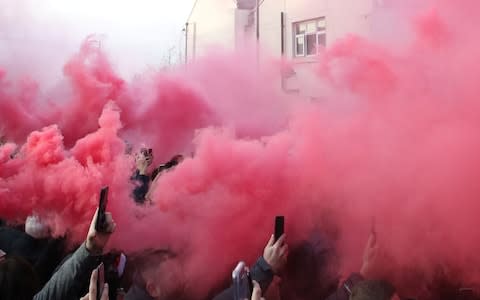  Liverpool fans let off smoke bombs as the Liverpool team bus arrives at the stadium - Credit: Action Images via Reuters/Carl Recine