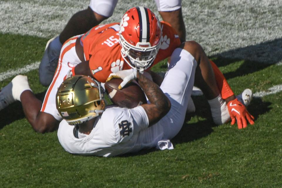 Clemson safety Andrew Mukuba (1) tackles Notre Dame receiver Chris Tyree (4) during the first quarter at Memorial Stadium in Clemson, S.C. Saturday, November 4, 2023.