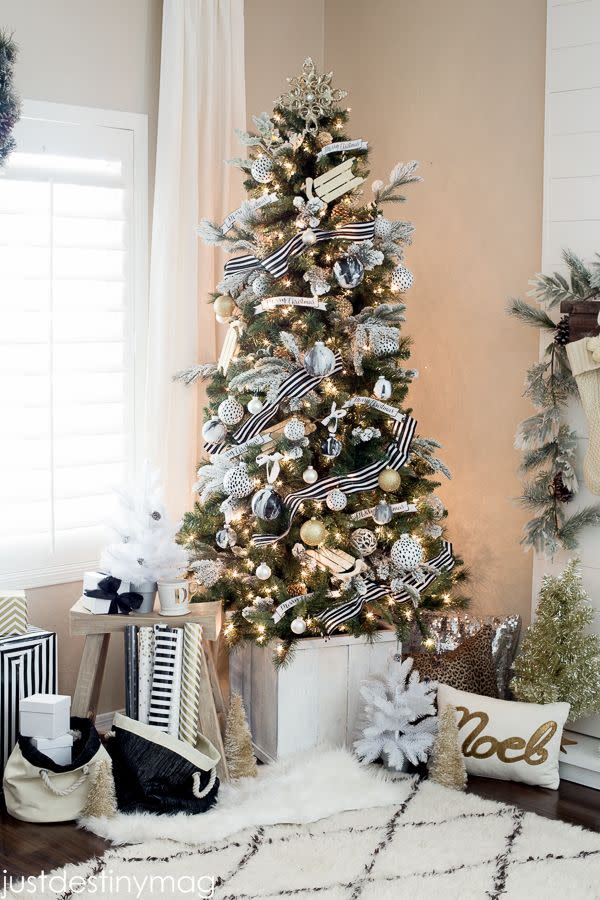 <p>Black-and-white striped ribbon wraps around a Christmas tree that's adorned with flocked branches and faux marble ornaments.</p><p><strong>Get the tutorial at <a href="http://justdestinymag.com/michaels-dream-tree-challenge/" rel="nofollow noopener" target="_blank" data-ylk="slk:Just Destiny;elm:context_link;itc:0;sec:content-canvas" class="link ">Just Destiny</a>.</strong></p><p><strong><a class="link " href="https://www.amazon.com/Black-White-Striped-Grosgrain-Ribbon/dp/B01CRM9L44/ref=sr_1_1_sspa?dchild=1&keywords=black+and+white+striped+ribbon&qid=1603207402&sr=8-1-spons&psc=1&spLa=ZW5jcnlwdGVkUXVhbGlmaWVyPUEyQ0dKRDlROU5PMTBJJmVuY3J5cHRlZElkPUExMDA5MjI5MlA0UFZLUjEwNlFLQyZlbmNyeXB0ZWRBZElkPUEwOTI2ODAySkhFMzlaQVU4TDAyJndpZGdldE5hbWU9c3BfYXRmJmFjdGlvbj1jbGlja1JlZGlyZWN0JmRvTm90TG9nQ2xpY2s9dHJ1ZQ%3D%3D&tag=syn-yahoo-20&ascsubtag=%5Bartid%7C10050.g.1251%5Bsrc%7Cyahoo-us" rel="nofollow noopener" target="_blank" data-ylk="slk:SHOP RIBBON;elm:context_link;itc:0;sec:content-canvas">SHOP RIBBON</a><br></strong></p>