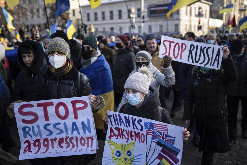 Demonstrators with Ukrainian national flags and posters march in the center of Kharkiv, Ukraine's second-largest city, Saturday, Feb. 5, 2022, just 40 kilometers (25 miles) from some of the tens of thousands of Russian troops massed at the border of Ukraine. After weeks of talks in various diplomatic formats have led to no major concessions by Russia and the U.S., it's unclear how much impact the trips will have. But Ukraine's Foreign Minister Dmytro Kuleba said Friday that "top-level visits seriously reduce challenges in the sphere of security and upset the Kremlin's plans." (AP Photo/Evgeniy Maloletka)