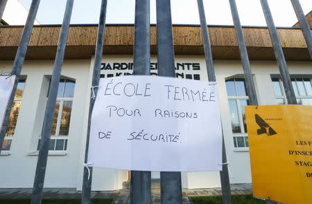 A sign that reads "school closed for security reason" is pictured at the entrance of a nursery school in Brussels, November 23, 2015, after security was tightened in Belgium following the fatal attacks in Paris. REUTERS/Yves Herman