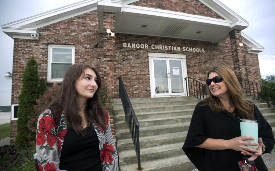 Olivia Carson and her mother, Amy Carson, in front of Bangor Christian Schools in Bangor, Maine, on Aug. 28, 2018. The Carson family is a plaintiff in a case before the U.S. Supreme Court that could enable religious schools, such as Bangor Christian, to receive taxpayer funds.<span class="copyright">Gabor Degre—The Bangor Daily/AP</span>