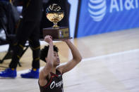 Portland Trail Blazers' Anfernee Simon holds the trophy after winning the Slam Dunk contest during basketball's NBA All-Star Game in Atlanta, Sunday, March 7, 2021. (AP Photo/Brynn Anderson)