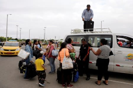 Venezuelan migrants take taxis after passing through the Binational Border Service Center of Peru, in Tumbes