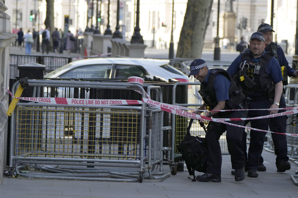 Police at the scene after a car collided with the gates of Downing Street in London in London, Thursday, May 25, 2023. Police say a car has collided with the gates of Downing Street in central London, where the British prime minister's home and offices are located. The Metropolitan Police force says there are no reports of injuries. Police said a man was arrested at the scene on suspicion of criminal damage and dangerous driving. It was not immediately clear whether the crash was deliberate. (AP Photo/Alastair Grant)