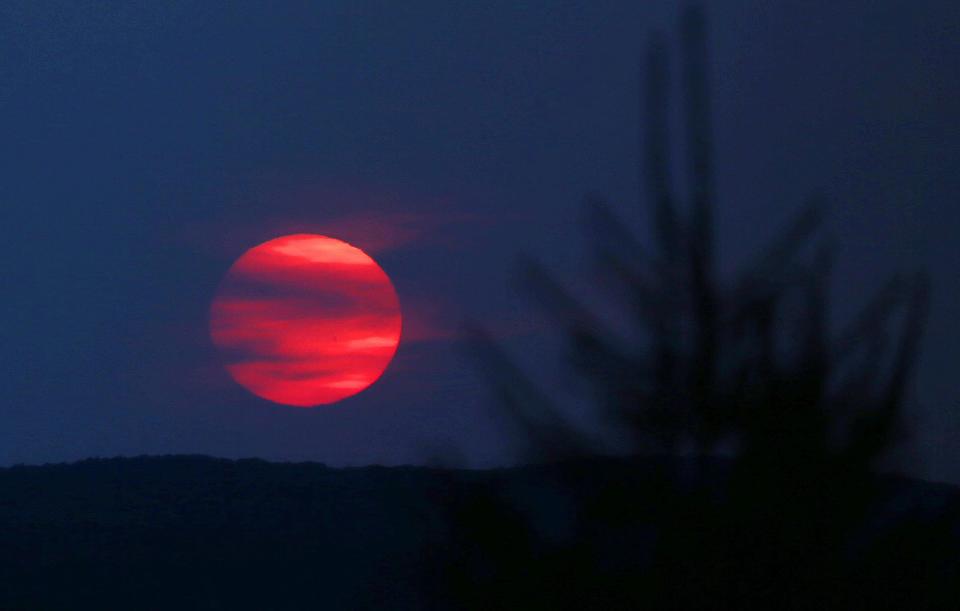 Smoke from the wildfires in Canada casts a haze over the sun as it sets in Putnam County as seen from Starr Ridge Road in Brewster May 27, 2023.