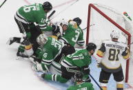 Dallas Stars goalie Anton Khudobin (35) makes a save against the Vegas Golden Knights as players crash in on him during the third period of Game 4 of the NHL hockey Western Conference final, Saturday, Sept. 12, 2020, in Edmonton, Alberta. (Jason Franson/The Canadian Press via AP)