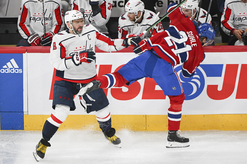Washington Capitals' Alex Ovechkin (8) checks Montreal Canadiens' Kaiden Guhle during the first period of an NHL hockey game Saturday, Feb. 17, 2024, in Montreal. (Graham Hughes/The Canadian Press via AP)