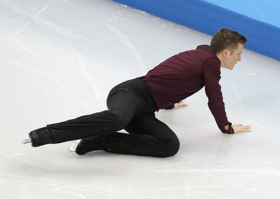 Jeremy Abbott of the United States falls as he competes in the men's team short program figure skating competition at the Iceberg Skating Palace during the 2014 Winter Olympics, Thursday, Feb. 6, 2014, in Sochi, Russia. (AP Photo/Vadim Ghirda)