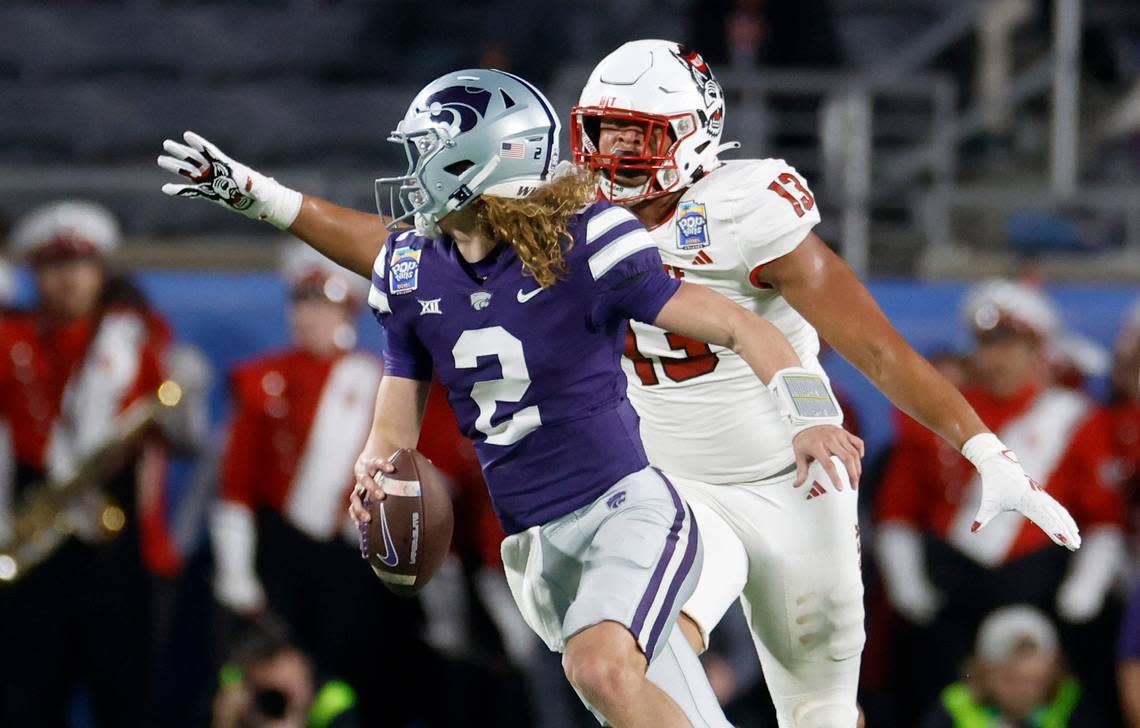 Kansas State quarterback Jake Rubley (2) escapes from N.C. State defensive end Travali Price (13) during the first half of N.C. State’s game against Kansas State in the Pop-Tarts Bowl at Camping World Stadium in Orlando, Fla., Thursday, Dec. 28, 2023. Ethan Hyman/ehyman@newsobserver.com