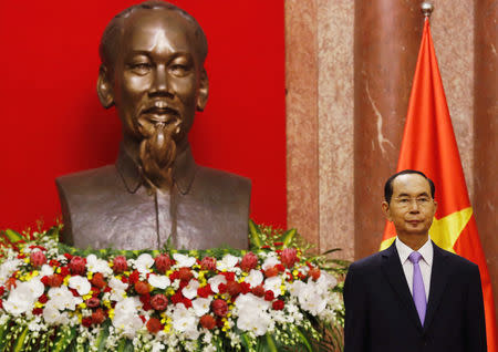 Vietnam's President Tran Dai Quang stands in front of a statue of Vietnamese revolutionary leader Ho Chi Minh and the Vietnamese national flag before a meeting at the Presidential Palace in Hanoi, Vietnam September 13, 2018. REUTERS/Kham/File Photo