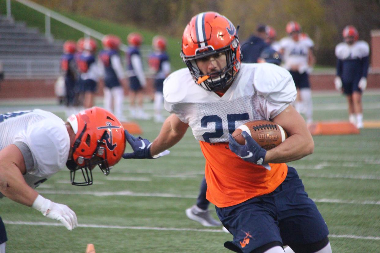 Hope running back  Elijah Smith stiff arms a teammate during position drills