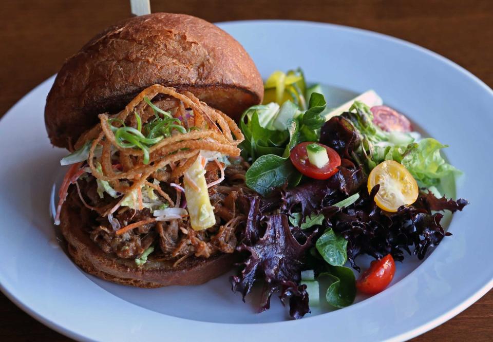 <p><strong>Kalua Pork Sandwich</strong></p><p>You won’t find this anywhere else in the country, and no one does this Hawaiian staple better than <a href="https://www.konosnorthshore.com/" rel="nofollow noopener" target="_blank" data-ylk="slk:Kono’s;elm:context_link;itc:0;sec:content-canvas" class="link ">Kono’s</a>. The pork is slow-roasted for twelve hours and served not only as a variation of sandwiches but also in a breakfast burrito, biscuit or nachos. Sandwiches include guava barbecue sauce, grilled onions, ham and bacon.</p>