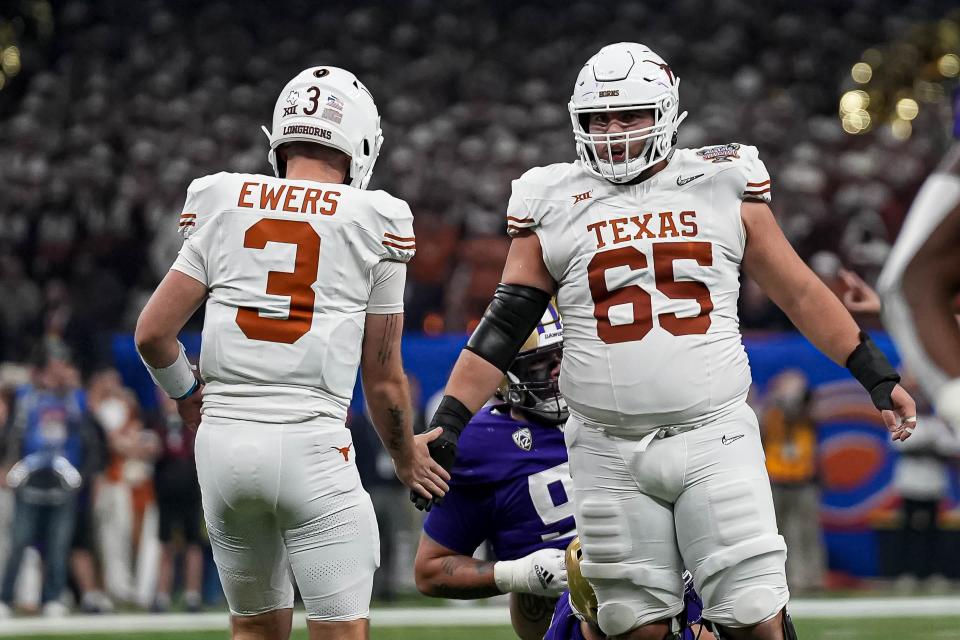 Texas center Jake Majors, right, celebrates a first down with quarterback Quinn Ewers during the Sugar Bowl loss to Washington in the College Football Playoff semifinals. Majors is back for his fourth season as a starter, saying, "I feel like there's a lot more left in the tank.”