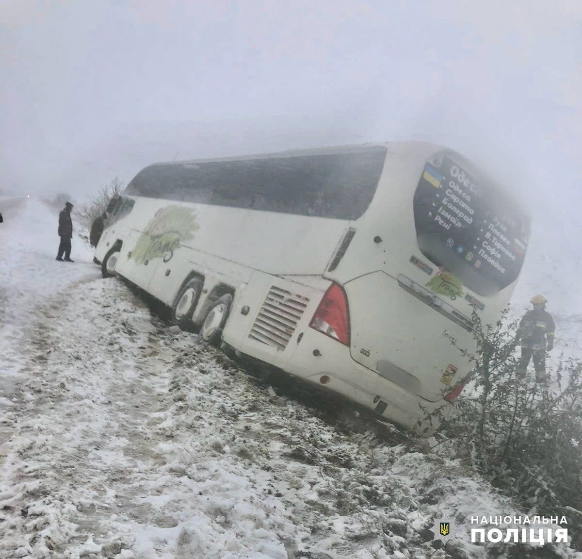 Emergency workers release a passenger bus which is stuck outside a road during a heavy snow storm in Odesa region (via REUTERS)