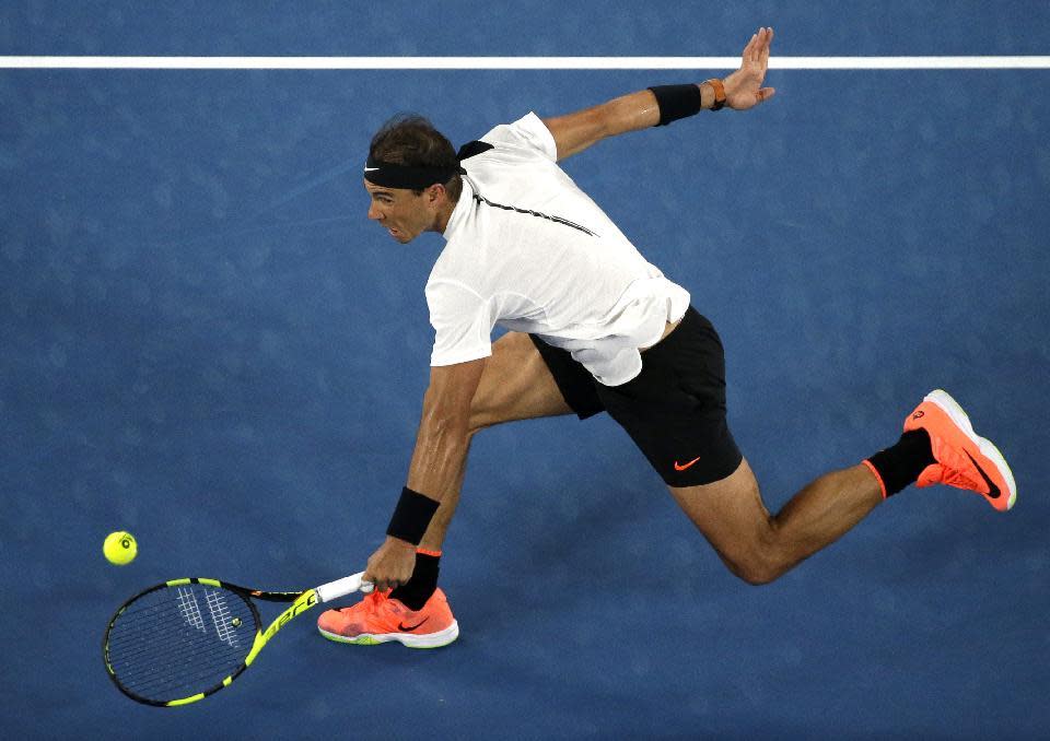 Spain's Rafael Nadal makes a backhand return to Marcos Baghdatis of Cyprus during their second round match at the Australian Open tennis championships in Melbourne, Australia, Thursday, Jan. 19, 2017. (AP Photo/Dita Alangkara)
