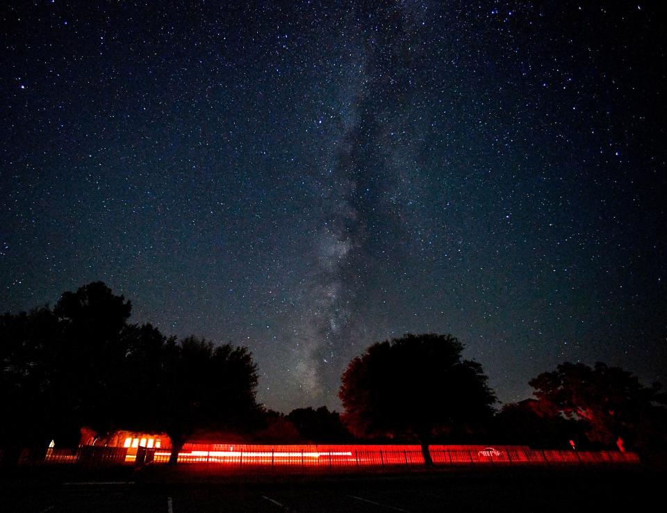 Car lights are blurred beneath the Milky Way in this long exposure at Abilene State Park during the Perseid meteor shower star party Aug. 13, 2023.