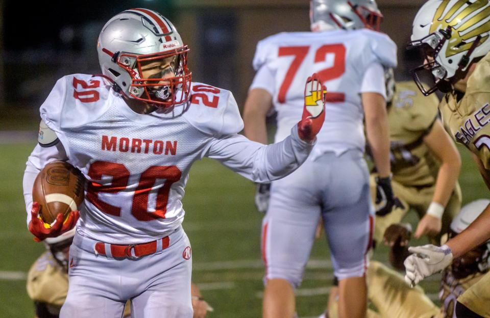 Morton's Seth Glatz (20) fends off a Dunlap defender in the second half Friday, Oct. 22, 2021 at Dunlap High School. The Potters defeated the Eagles 42-7.