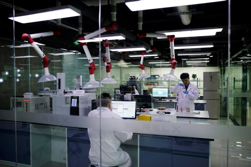 Engineers work in a lab of Chinese e-cigarette company Relx in Shenzhen