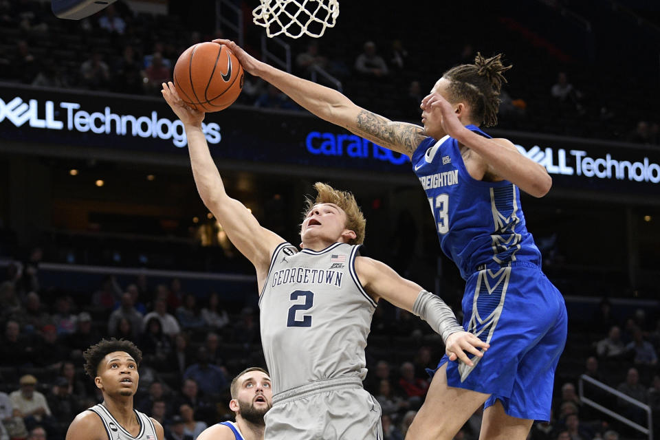 Creighton forward Christian Bishop (13) blocks Georgetown guard Mac McClung (2) during the second half of an NCAA college basketball game, Wednesday, Jan. 15, 2020, in Washington. Georgetown won 83-80. (AP Photo/Nick Wass)