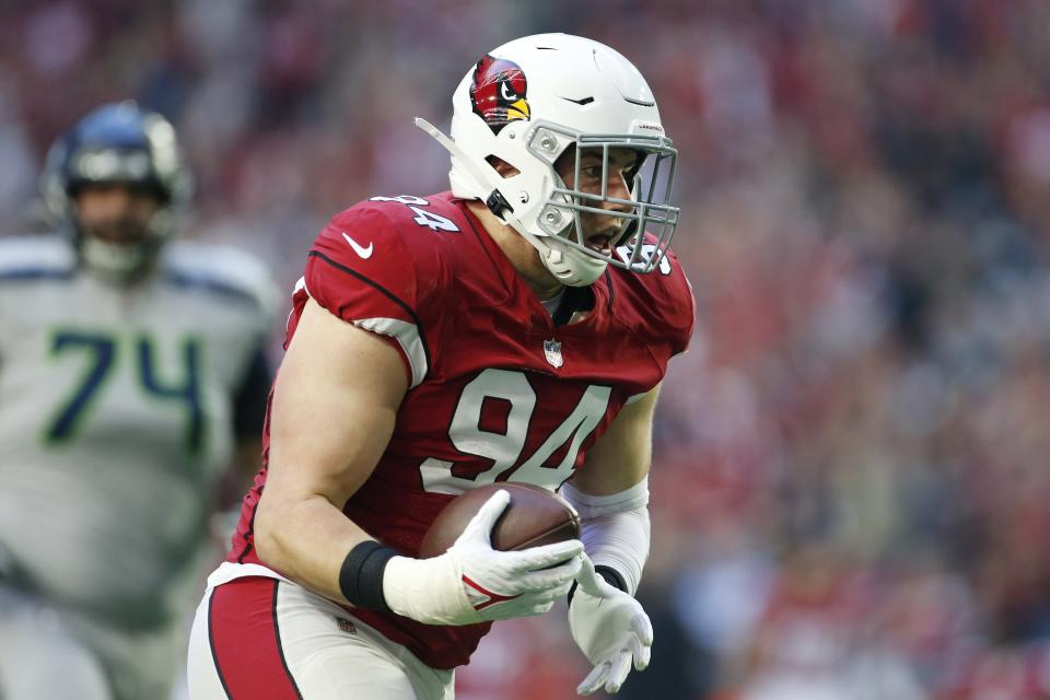 Arizona Cardinals defensive end Zach Allen (94) returns a fumble for a touchdown as Seattle Seahawks offensive tackle Jake Curhan (74) looks on during the first half of an NFL football game Sunday, Jan. 9, 2022, in Glendale, Ariz. (AP Photo/Ralph Freso)