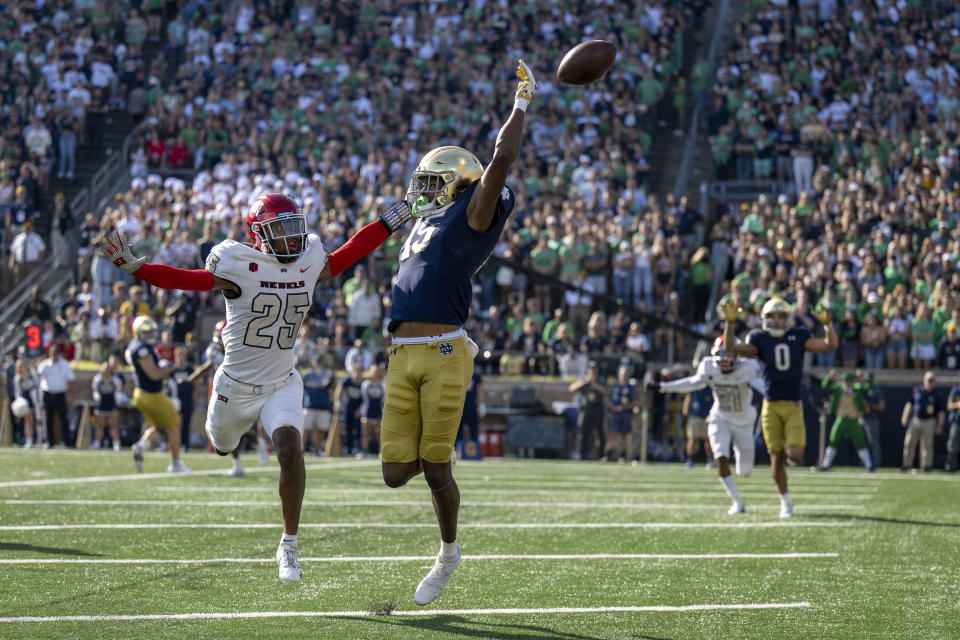 Notre Dame wide receiver Tobias Merriweather (15) misses a pass in front of UNLV defensive back Jordyn Morgan (25) during the second quarter of an NCAA college football game, Saturday, Oct. 22, 2022, in South Bend, Ind. (AP Photo/Marc Lebryk)