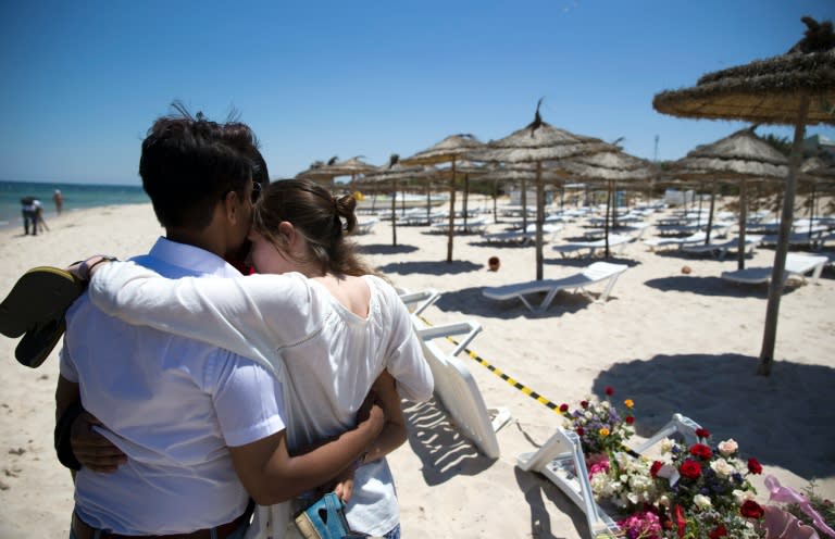 People react at the site of a shooting attack on the beach in front of the Riu Imperial Marhaba Hotel in Port el Kantaoui, on the outskirts of Sousse south of the capital Tunis, on June 27, 2015