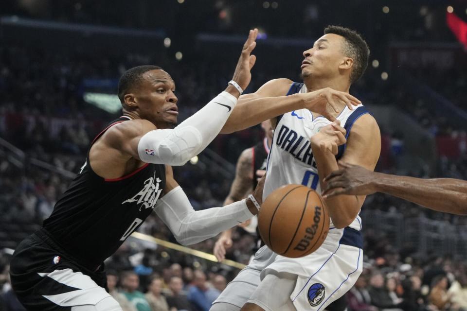 The Clippers' Russell Westbrook knocks the ball out of the hands of the Mavericks' Dante Exum