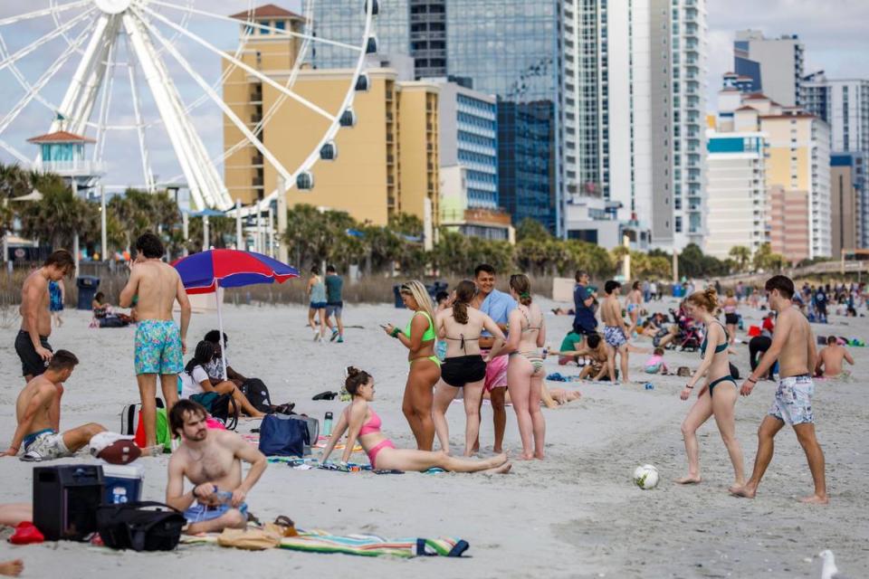 Students play games and hang out on the beach in the downtown section of Myrtle Beach, S.C. Thousands of students visit the Grand Strand from late February to early April from Spring Break every year. March 17, 2022.