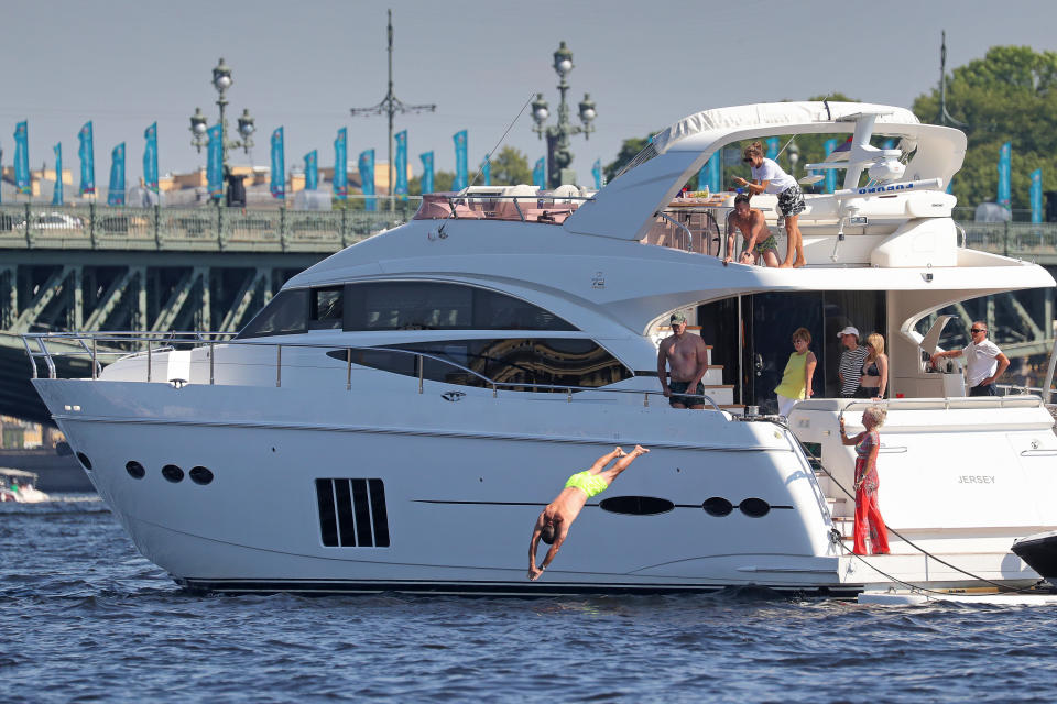 ST PETERSBURG, RUSSIA - JUNE 19, 2021: A man jumps into the Neva River from a yacht. The temperature in St Petersburg has reached 30.7°C, breaking the record of 1905. Peter Kovalev/TASS (Photo by Peter Kovalev\TASS via Getty Images)