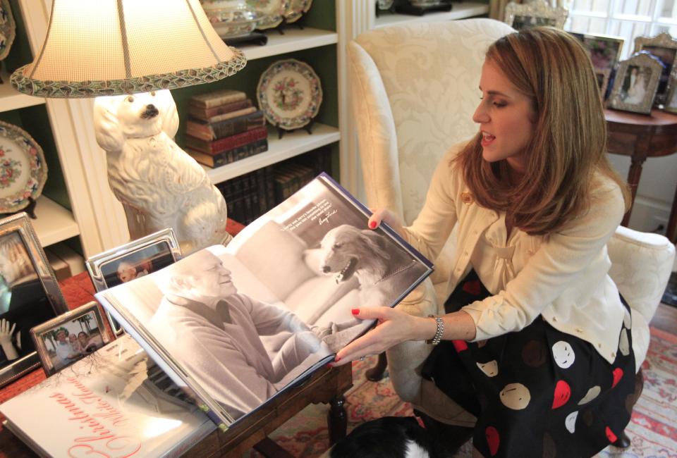 In this photo made Tuesday, Oct. 16, 2012, Jennifer B. Pickens shows her book titled "Pets at the White House," during an interview at her home in Dallas. Pickens compiled stories and photos of pets that lived in the White House for her latest book. (AP Photo/LM Otero)