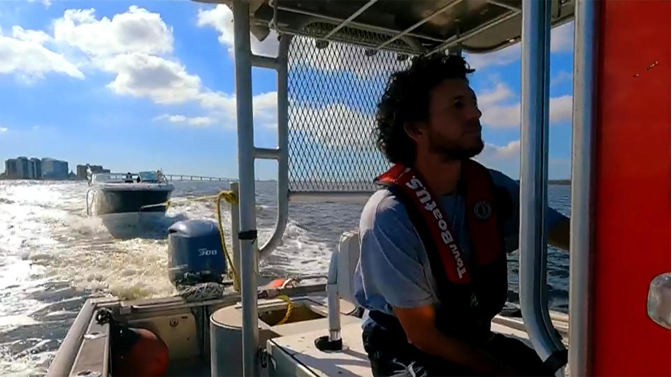 Andres Rosado tows a boat.  / Credit: CBS News