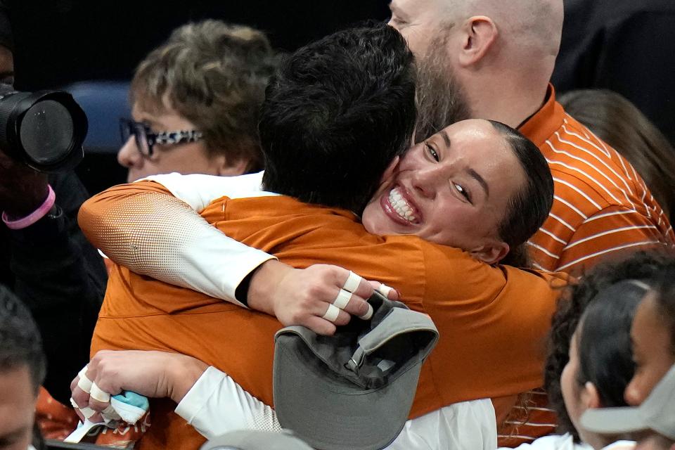 Texas outside hitter Madisen Skinner shares a joyful hug after her team swept Nebraska in the championship match at the NCAA women's volleyball tournament Sunday in Tampa, Fla.
