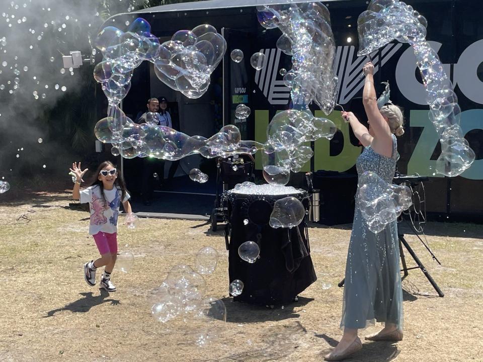 Children play in the bubbles at LIV Golf Miami's Fan Village.