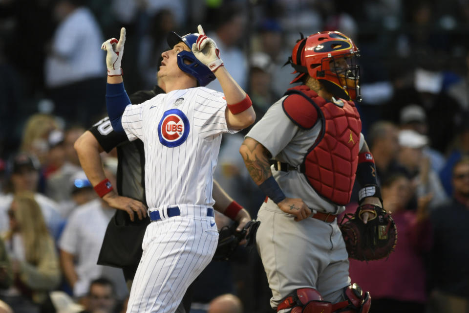 Chicago Cubs' Frank Schwindel celebrates at home plate after hitting a solo home run, next to St. Louis Cardinals catcher Yadier Molina during the third inning of a baseball game Thursday, June 2, 2022, in Chicago. (AP Photo/Paul Beaty)
